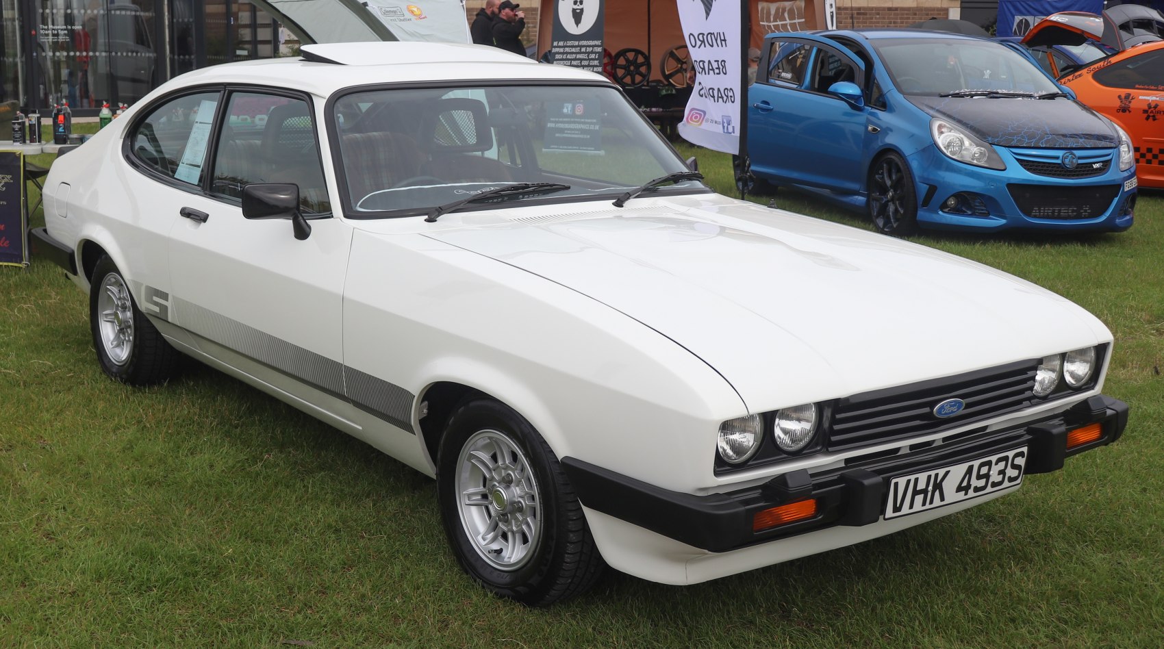 Vintage white coupe with quad headlights and detailed alloy wheels