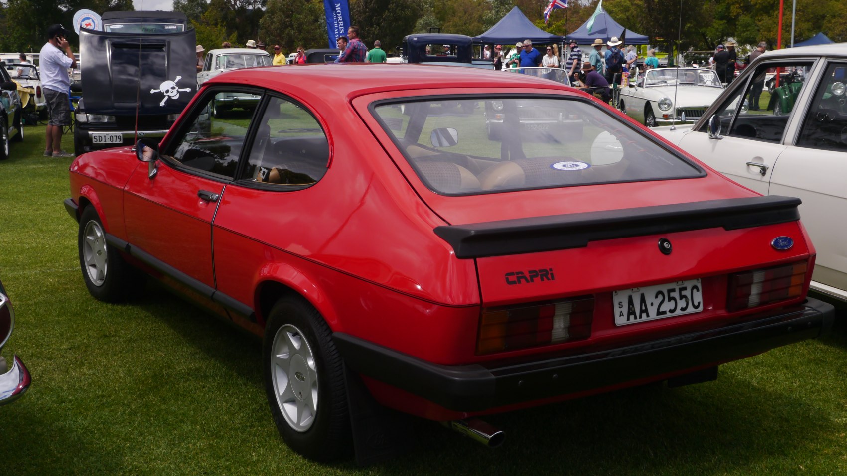 Rear view of red sporty hatchback with black spoiler and distinctive taillights