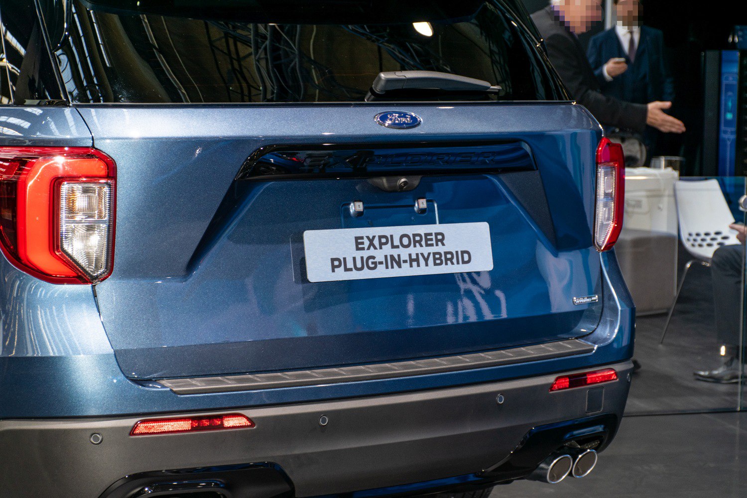 Rear view of a plug-in hybrid SUV with dual exhausts and hybrid badge
