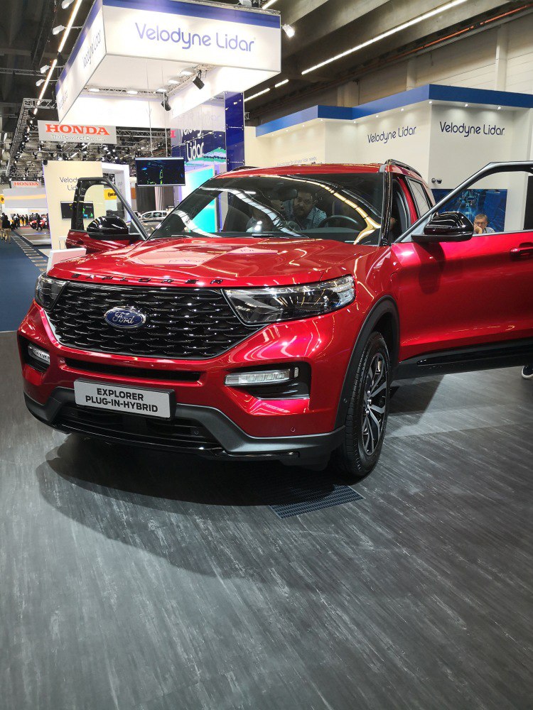 Red SUV front view with sleek grille and LED headlights