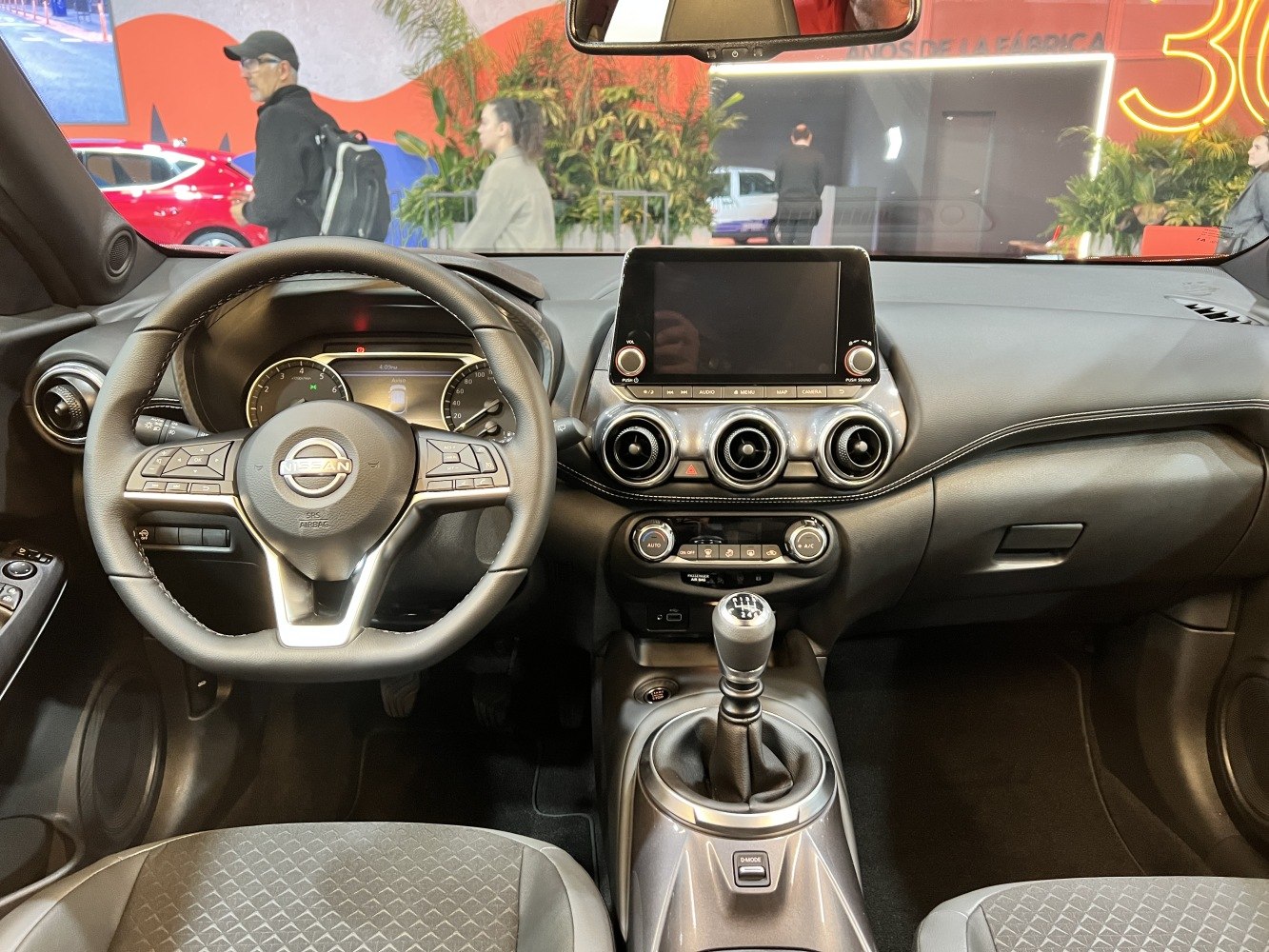 Manual transmission interior with central touchscreen and round air vents