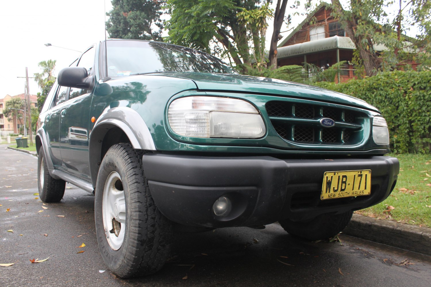 Front view showing headlights, grille, and black bumper of a mid-90s SUV