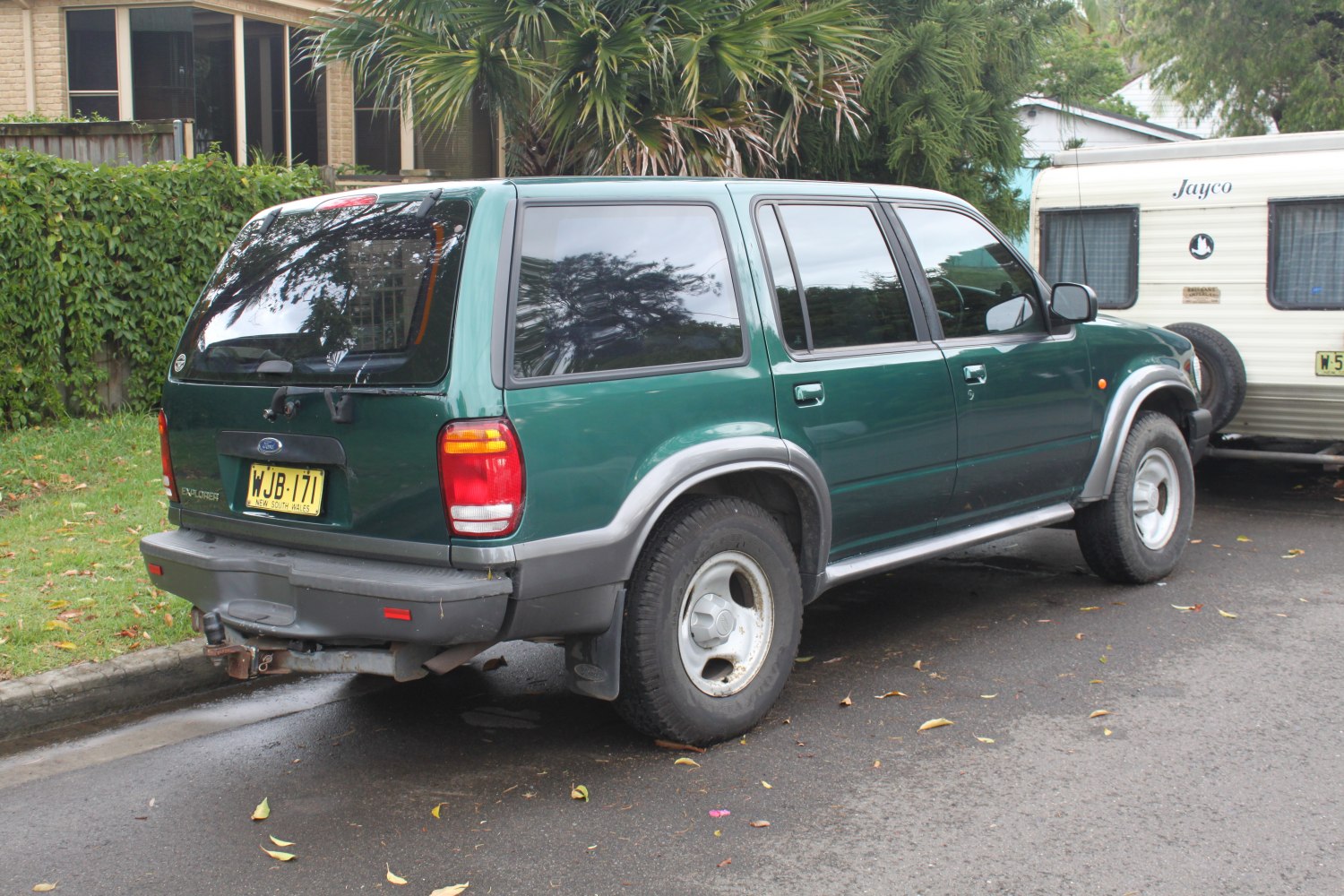 Rear and side profile of a classic 1990s SUV with tinted windows and alloy wheels