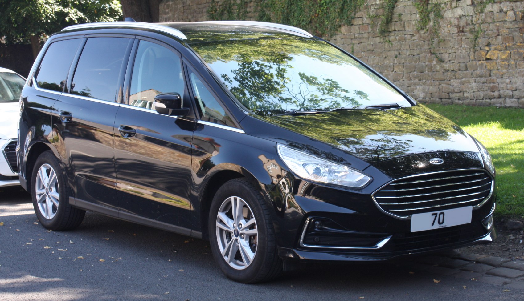 Black MPV with sleek front grille and alloy wheels