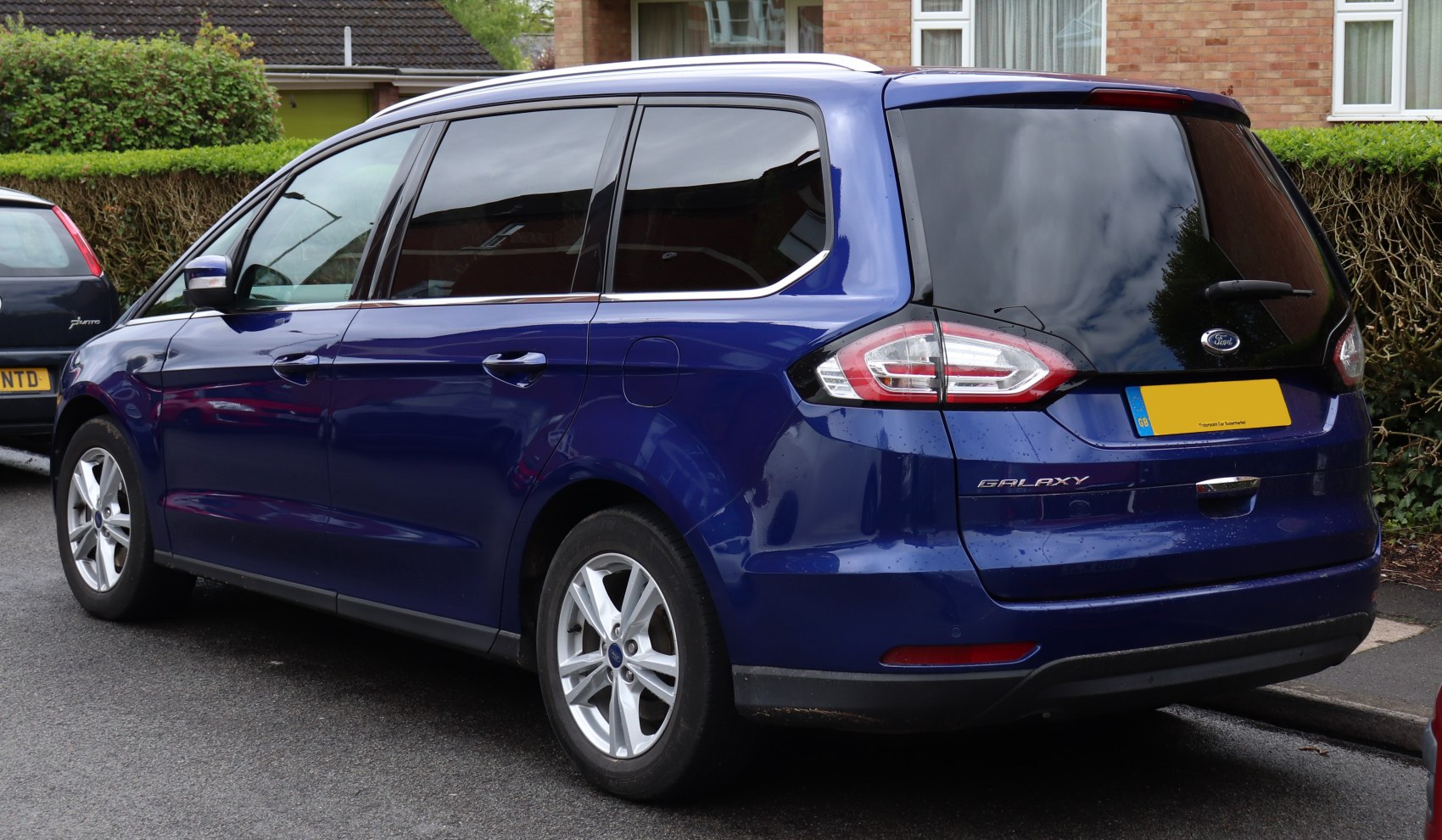 Rear and side view of MPV with tinted windows and modern taillights