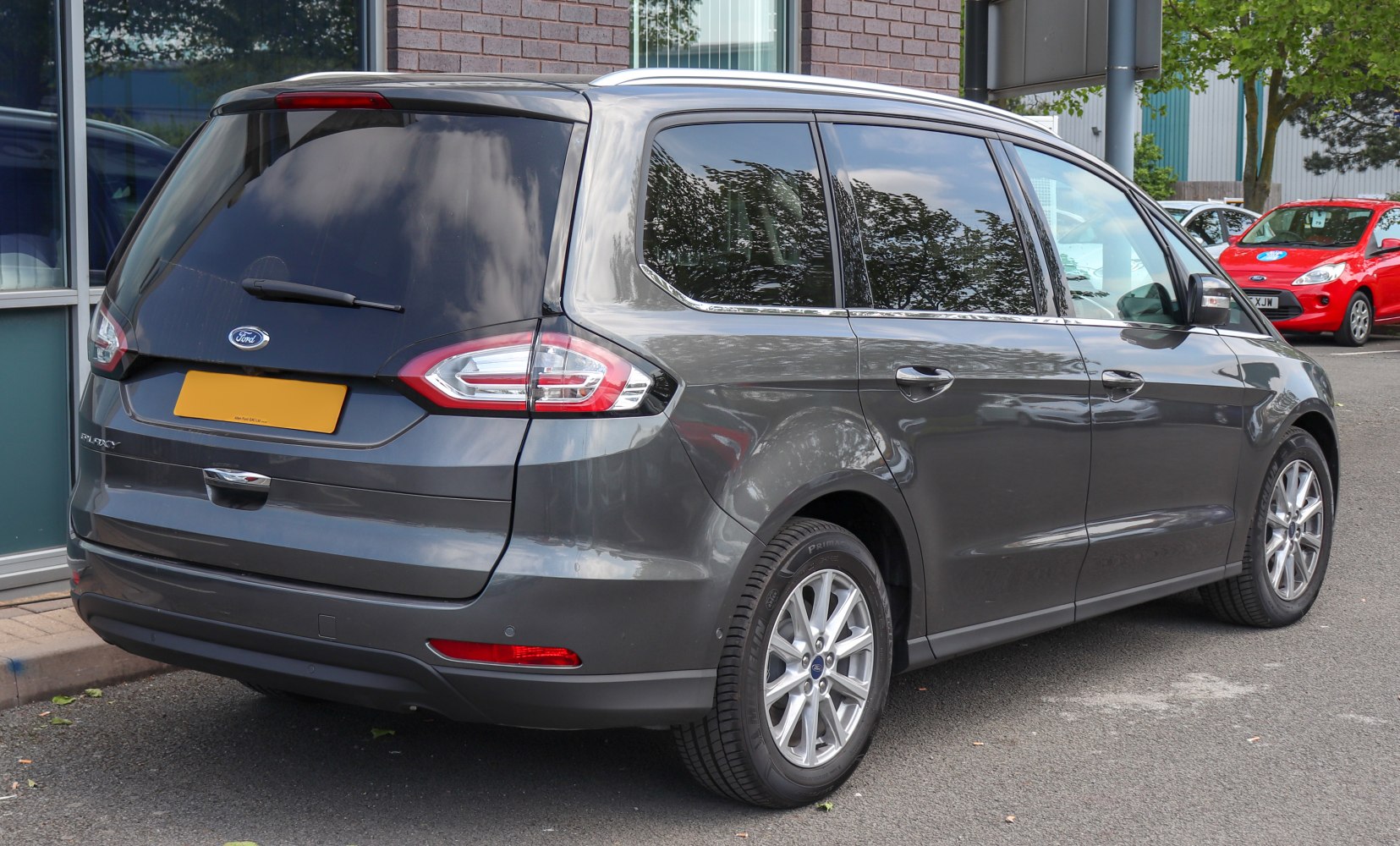 Rear and side view of large MPV with distinct taillights and window design