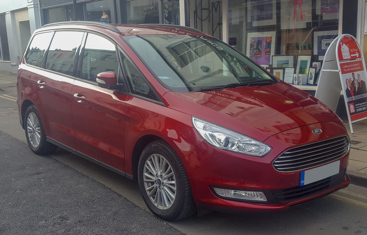 Red MPV with sleek front design and alloy wheels