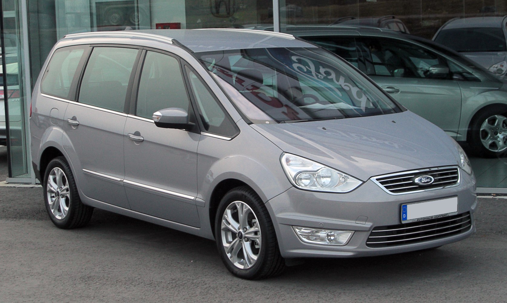 Silver MPV with modern headlights and alloy wheels, front side view