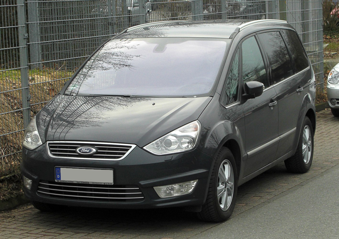 Front-side view of modern MPV with alloy wheels and tinted windows