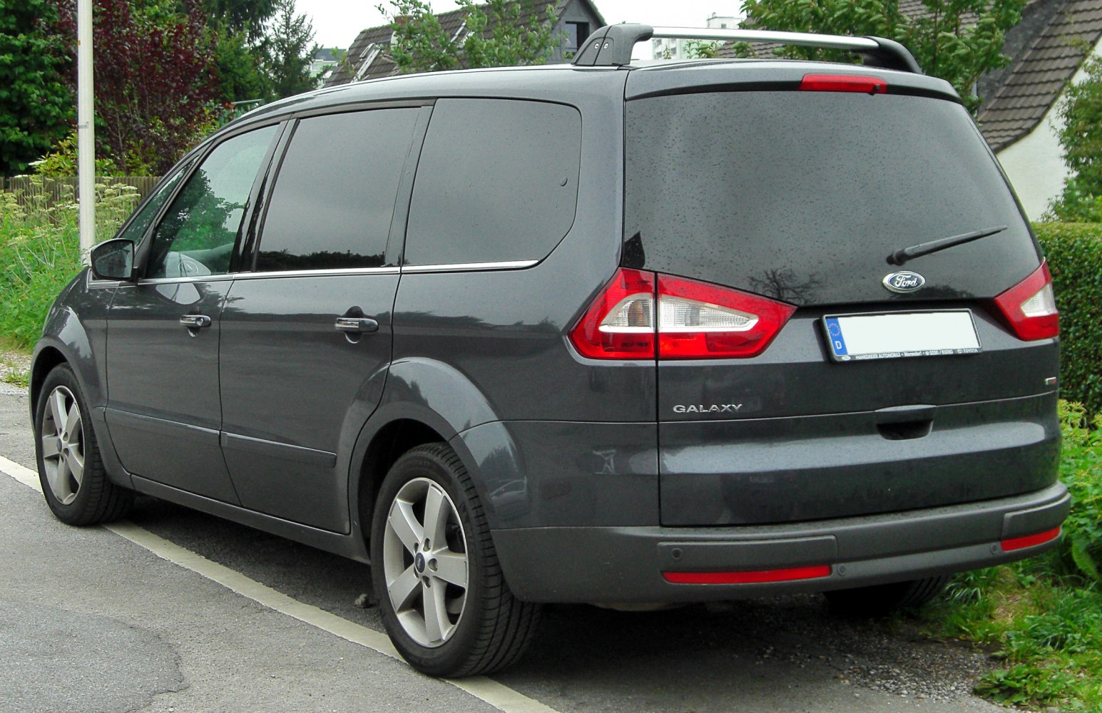 Rear side of a MPV with tinted windows and distinctive taillights