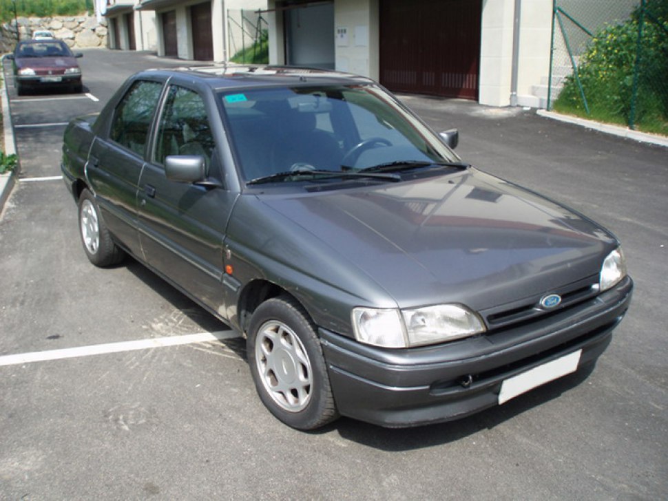Front side view of a gray four-door sedan with alloy wheels.