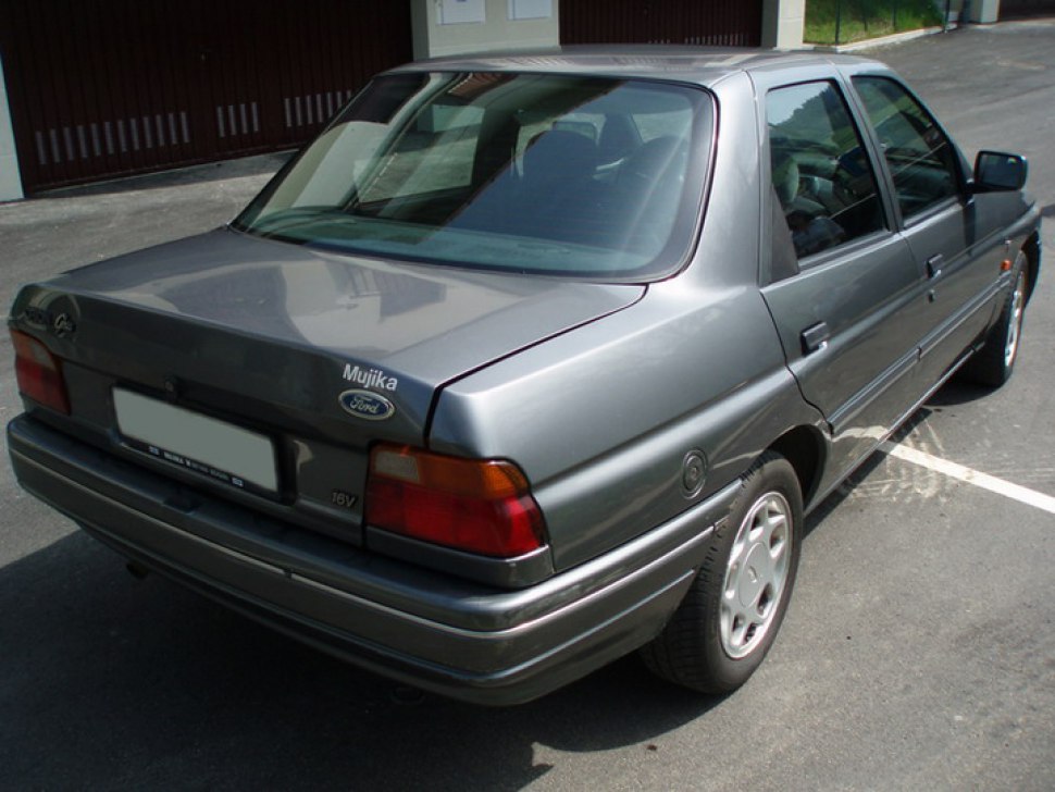 Rear and side profile of a sedan with classic 90s rear lights and 16V badge.