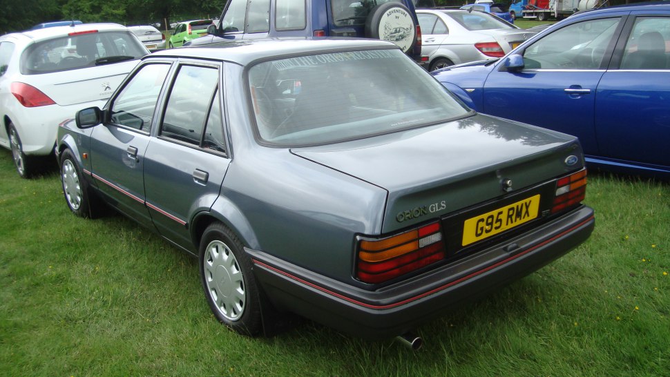 Rear view of a classic four-door sedan with distinctive tail lights and boxy design.