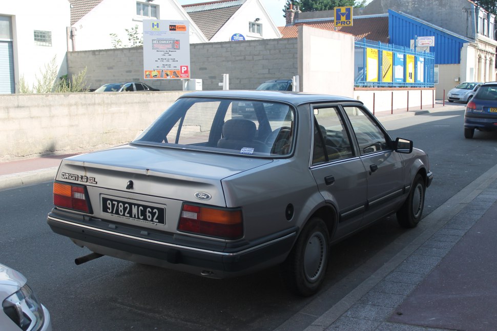 Rear view of classic four-door sedan with distinctive tail lights and boxy trunk design
