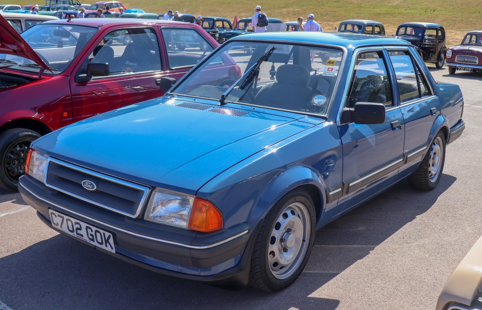 Classic blue sedan with boxy design and round rims