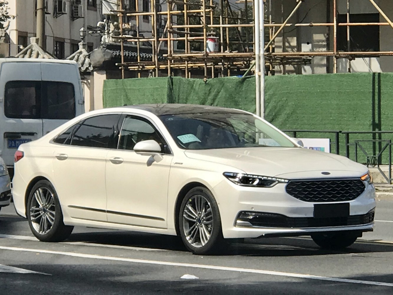 White sedan with LED headlights and honeycomb front grille