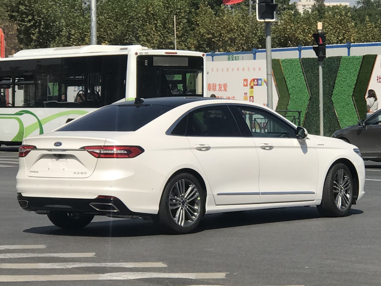 White sedan rear side with dual exhaust and LED tail lights