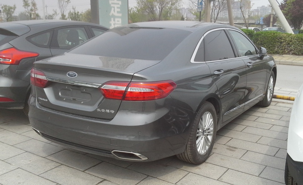 Rear view of sedan with dual exhaust and distinct taillights