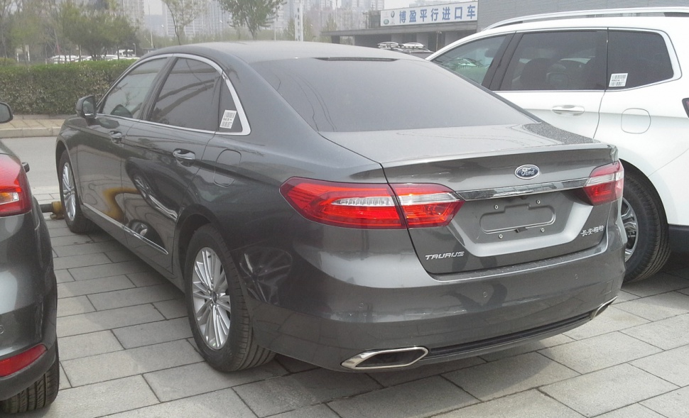Rear view of a sedan with chrome trim and dual exhaust