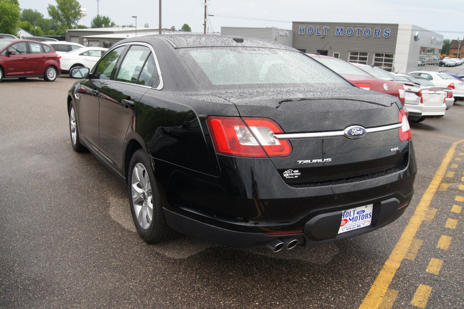 Rear view of sedan with dual exhaust and modern taillights
