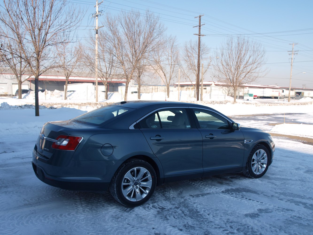 Sleek rear side view with chrome wheels in snowy setting