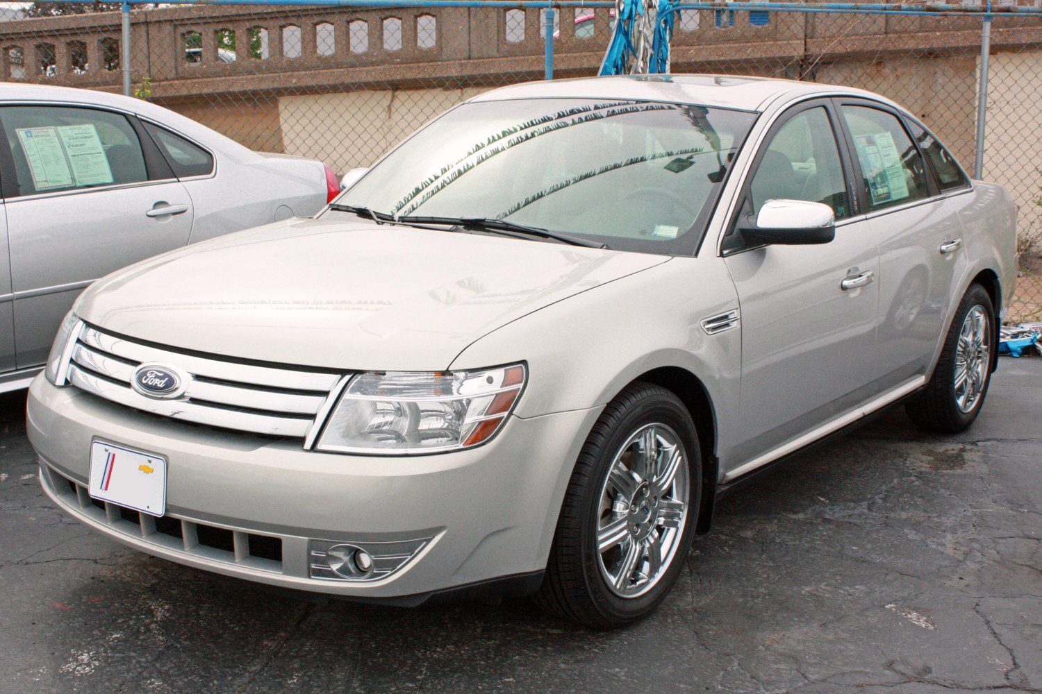 Mid-size sedan with chrome multi-bar grille and alloy wheels