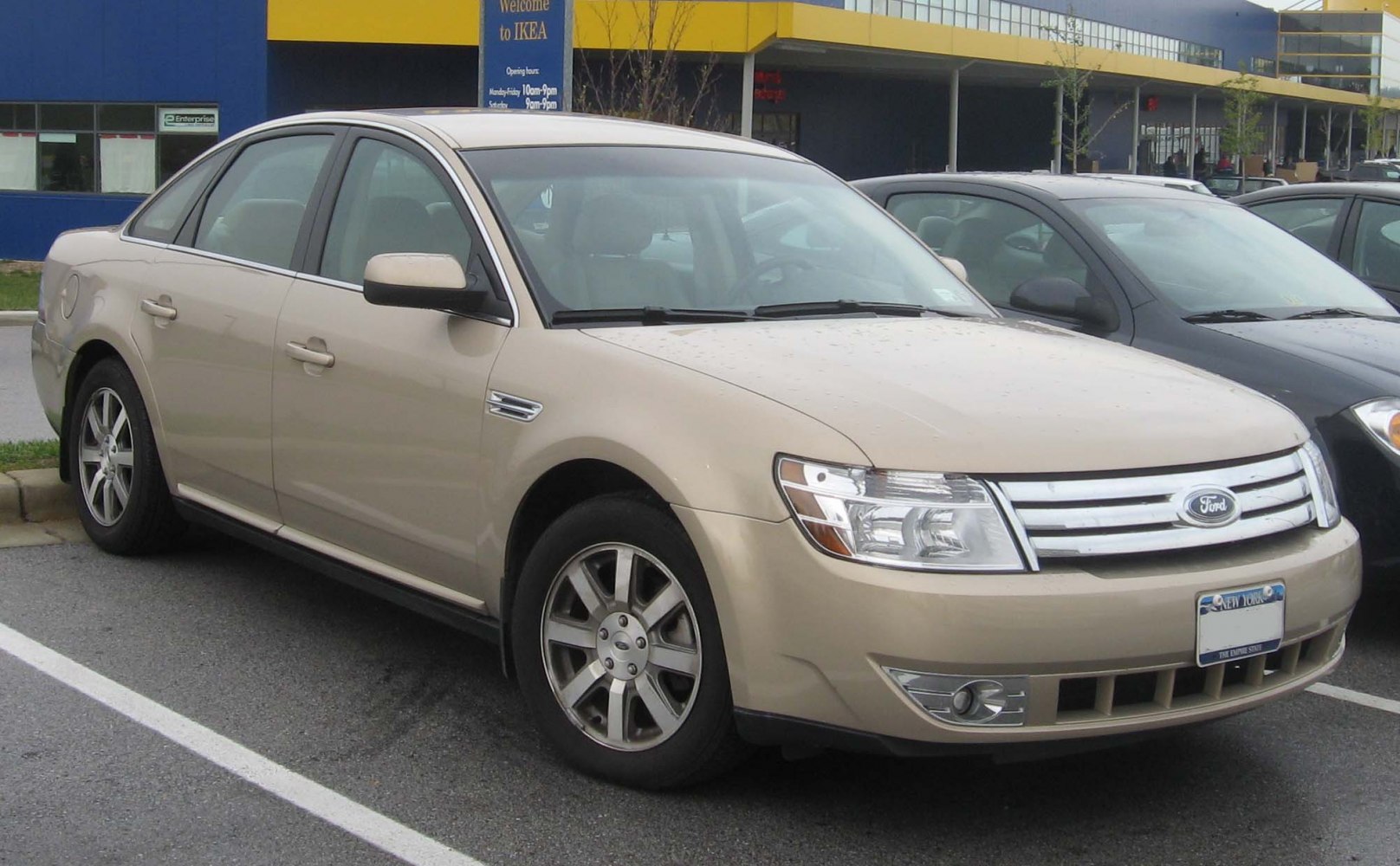Beige sedan with front grille and alloy wheels
