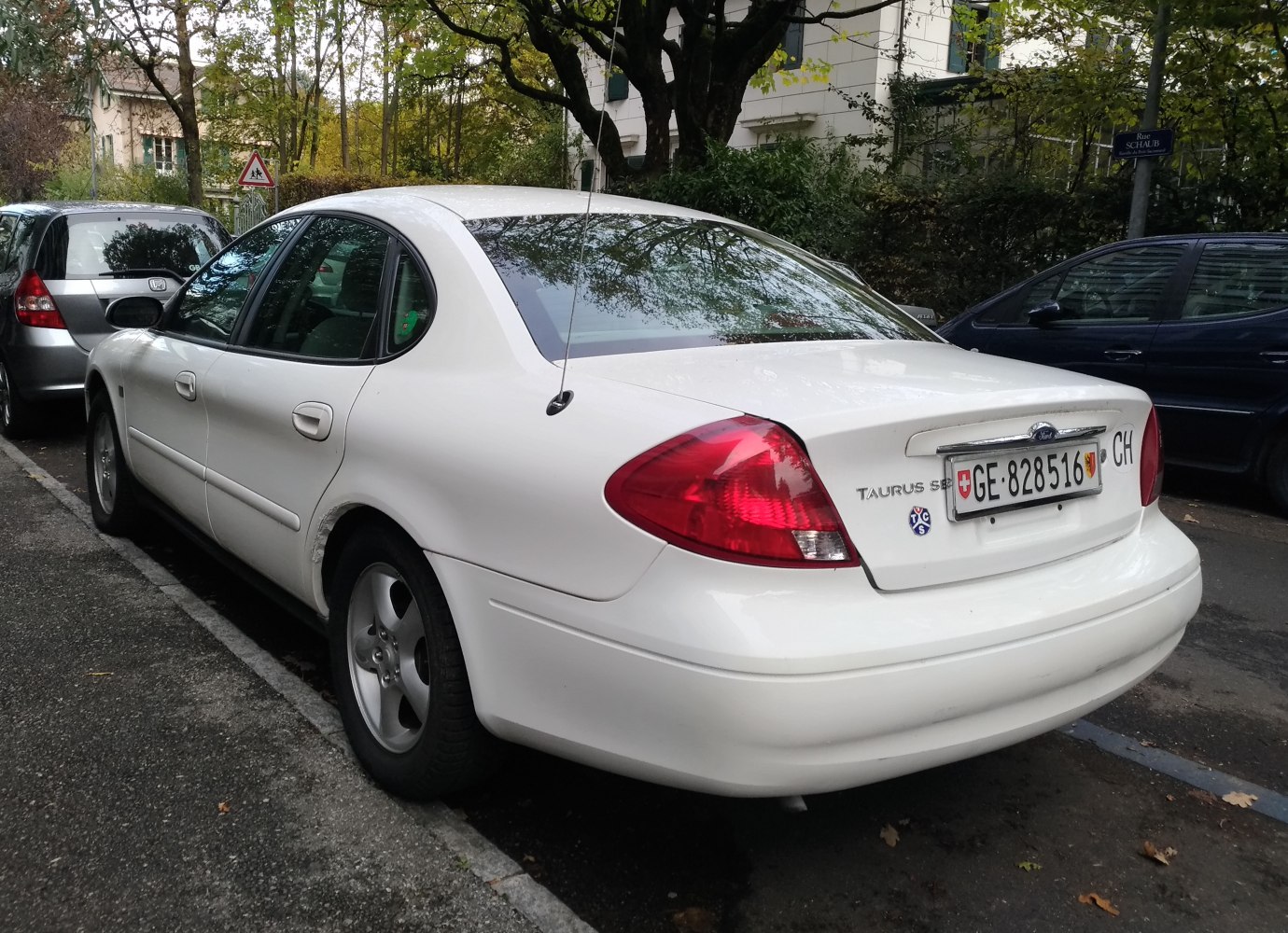 Rear sedan view with rounded taillights and alloy wheels