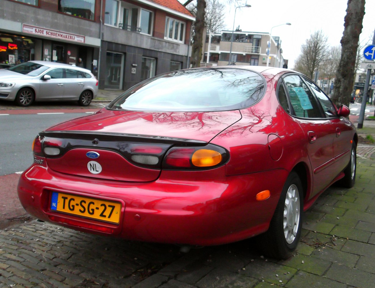 Rear view with rounded tail lights and smooth, aerodynamic design.