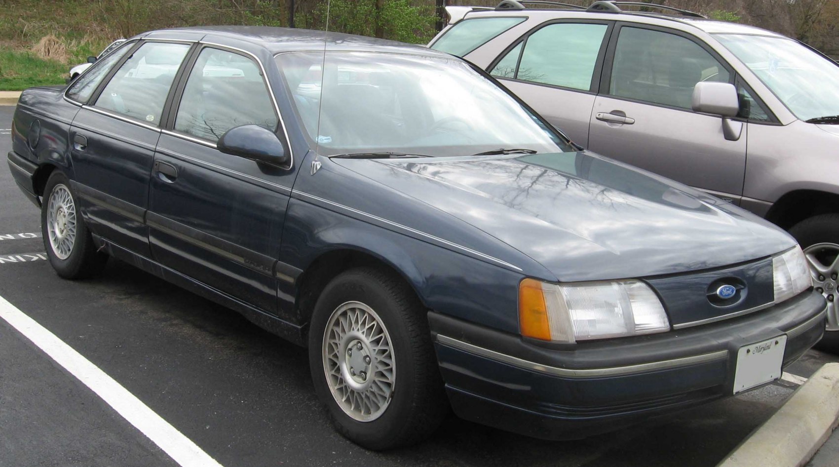1980s sedan front side view with alloy wheels and classic design