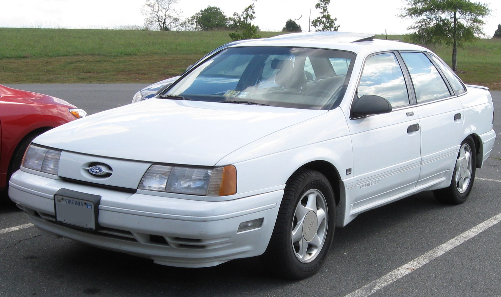 Aerodynamic 4-door sedan with rounded front and classic 80s styling