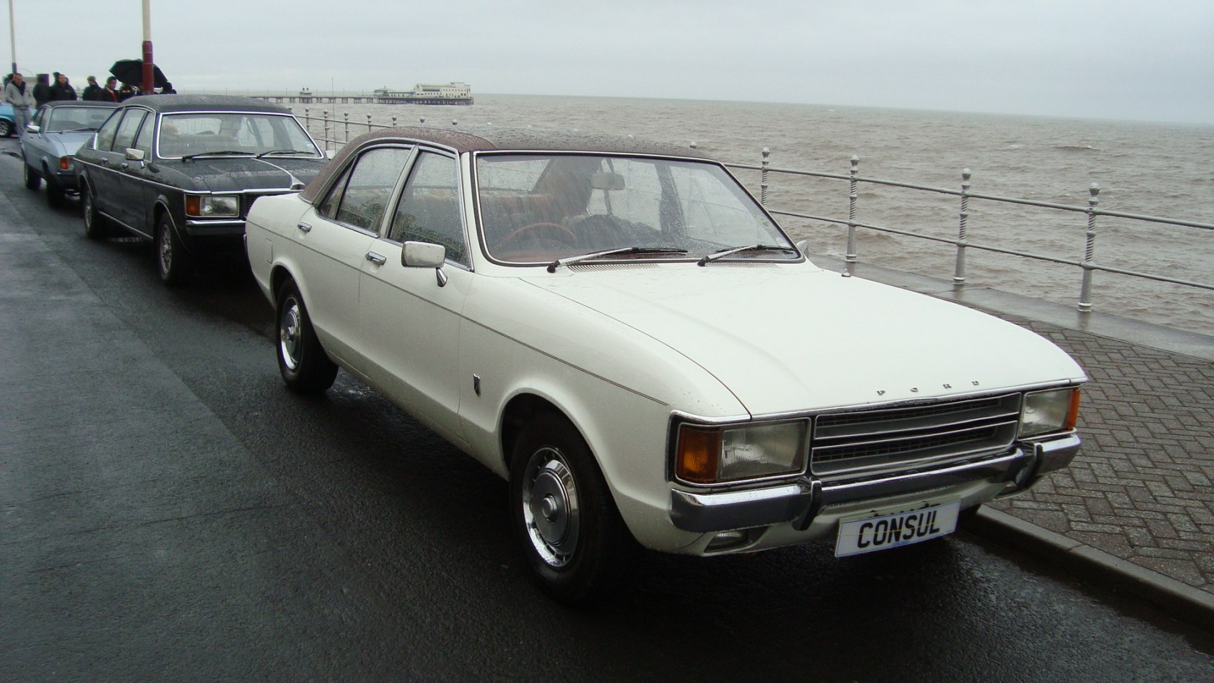 Classic sedan with vinyl roof, chrome hubcaps, and rectangular headlights