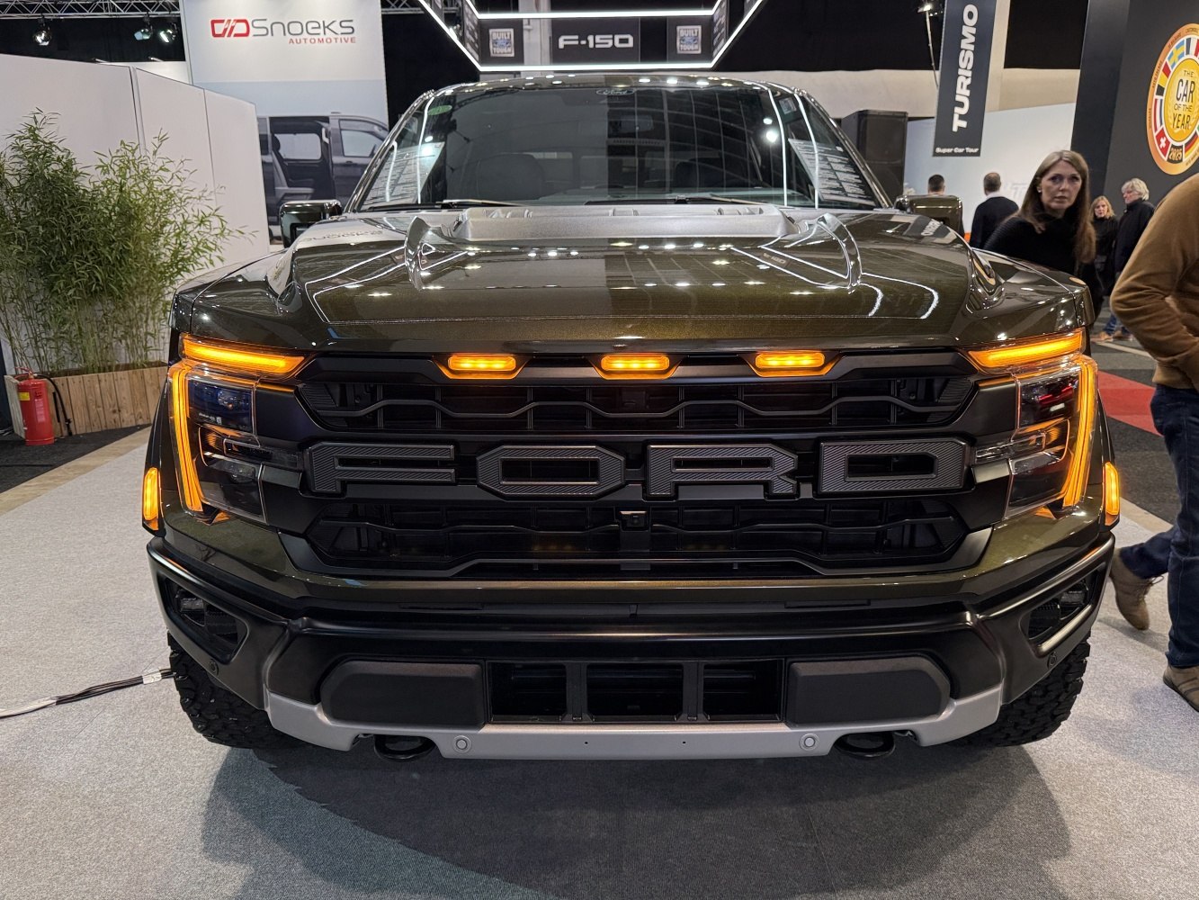 Front view of a black truck with amber LED marker lights and bold grille design