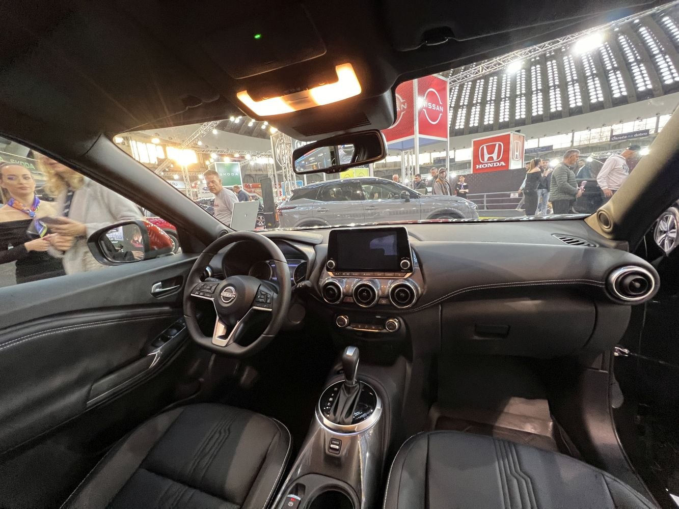 Modern car interior with dashboard, steering wheel, and center console.