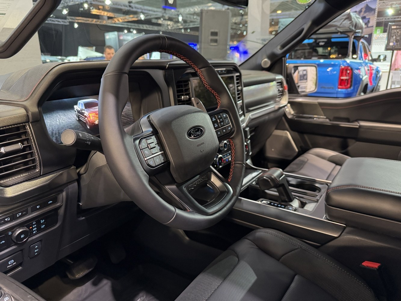 Modern steering wheel with control buttons and digital dashboard display
