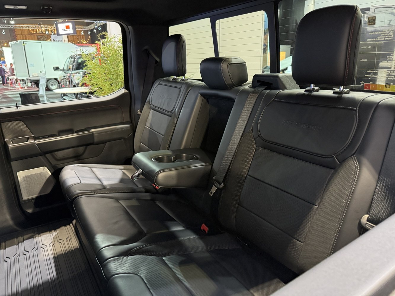 Black leather rear seats with fold-down armrest and cup holders