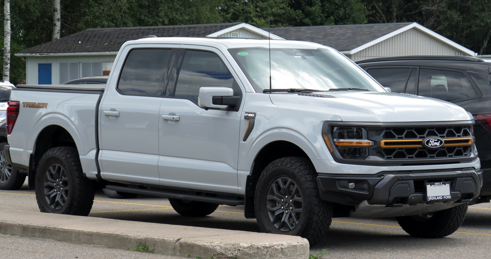 SuperCrew pickup with black honeycomb grille and offroad tires
