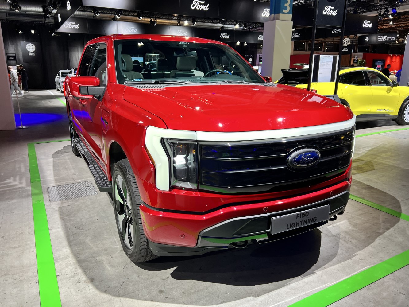 Front angled view of red pickup with LED headlights and modern grille