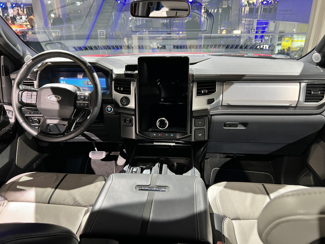 Dashboard, steering wheel, large touchscreen display, and premium seating interior