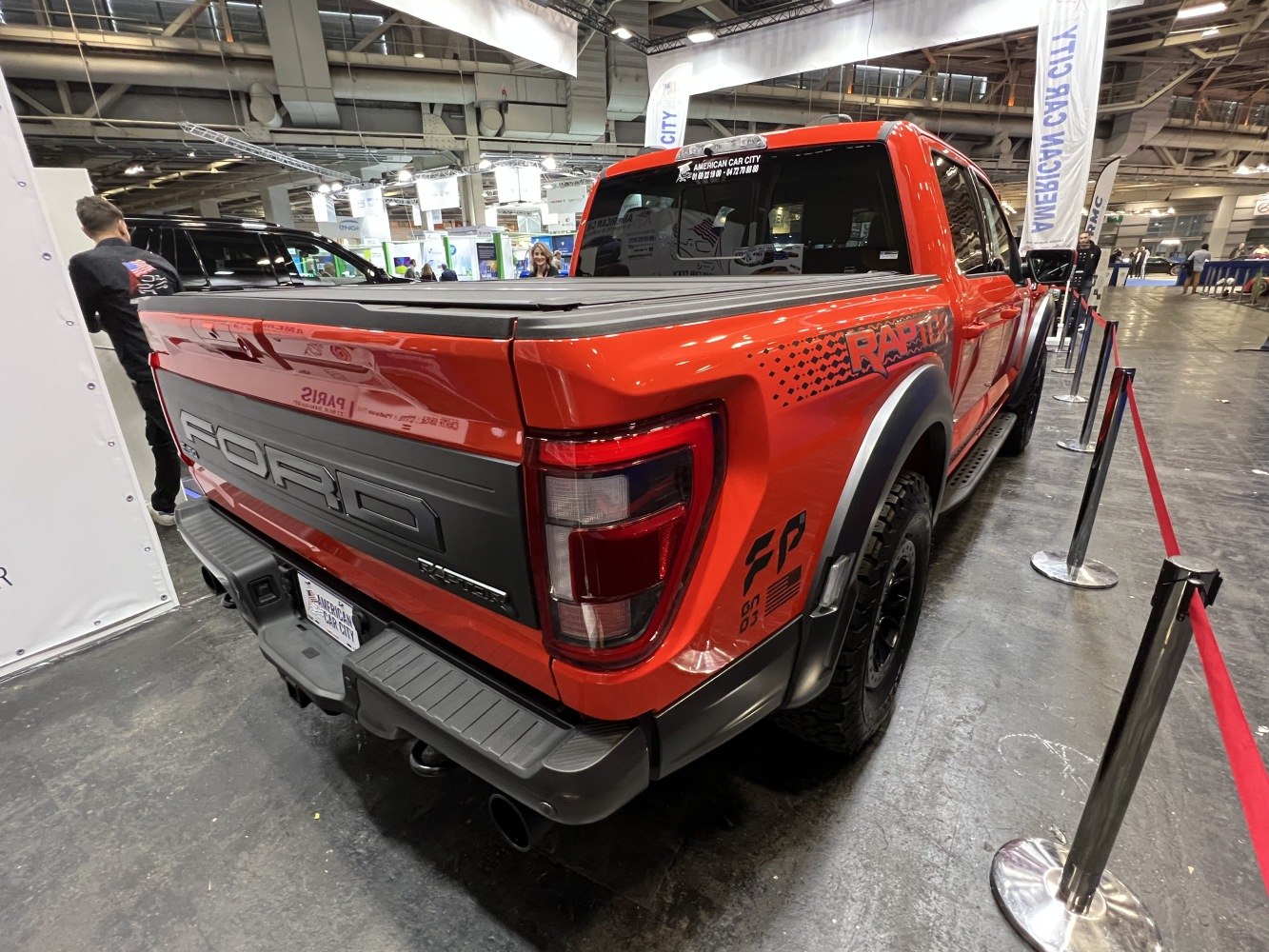 Rear view of red RAPTOR pickup with tailgate and tail lights