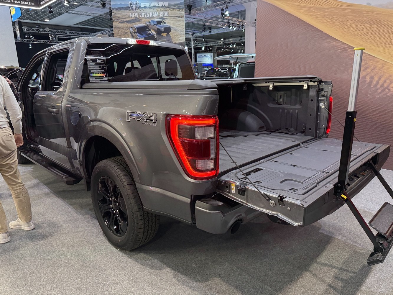 Pickup truck with open tailgate bed and black wheels