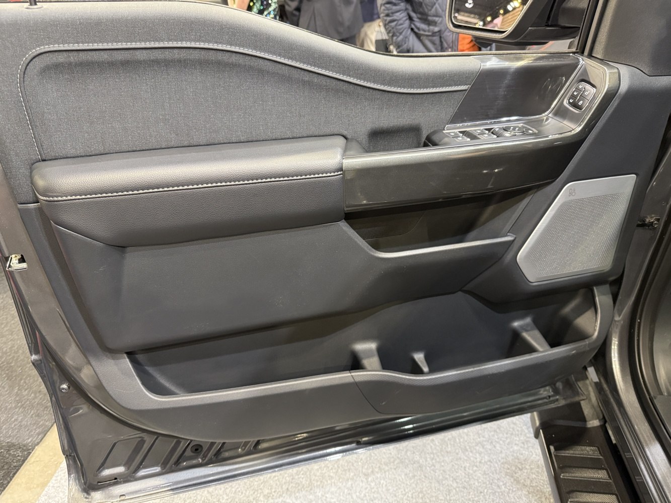 Modern truck door panel with control buttons and storage pockets
