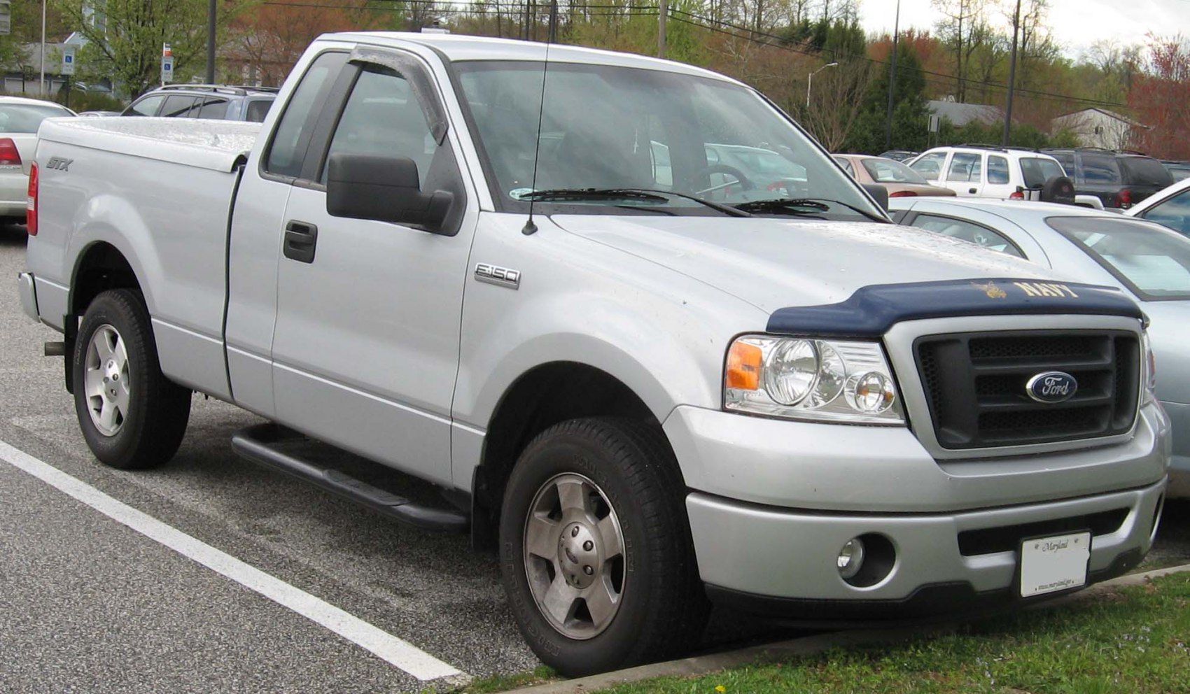 Silver pickup truck with Regular Cab and front grill