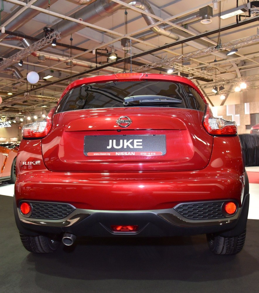 Rear view of compact crossover SUV with taillights and exhaust pipe visible