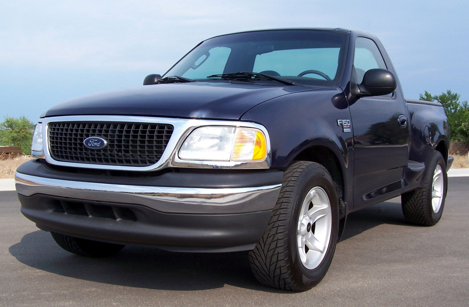 Front view of a pickup truck with classic grille and headlights