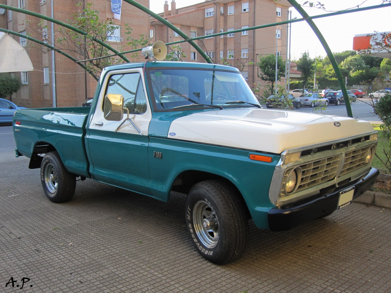 Classic regular cab pickup truck front side with two-tone paint and vintage grille.