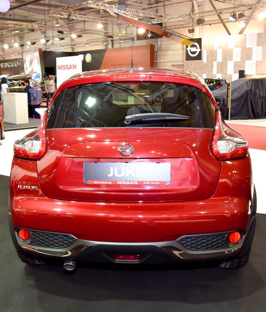 Rear view of a red compact SUV with distinctive taillights and rear wiper