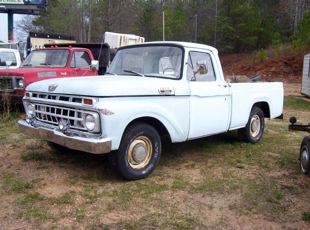 Classic vintage pickup truck with boxy body and distinctive front grille.