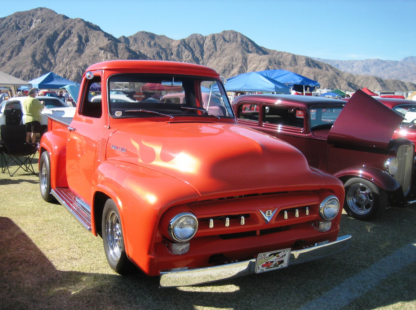 Classic vintage pickup truck with rounded fenders and custom orange paint