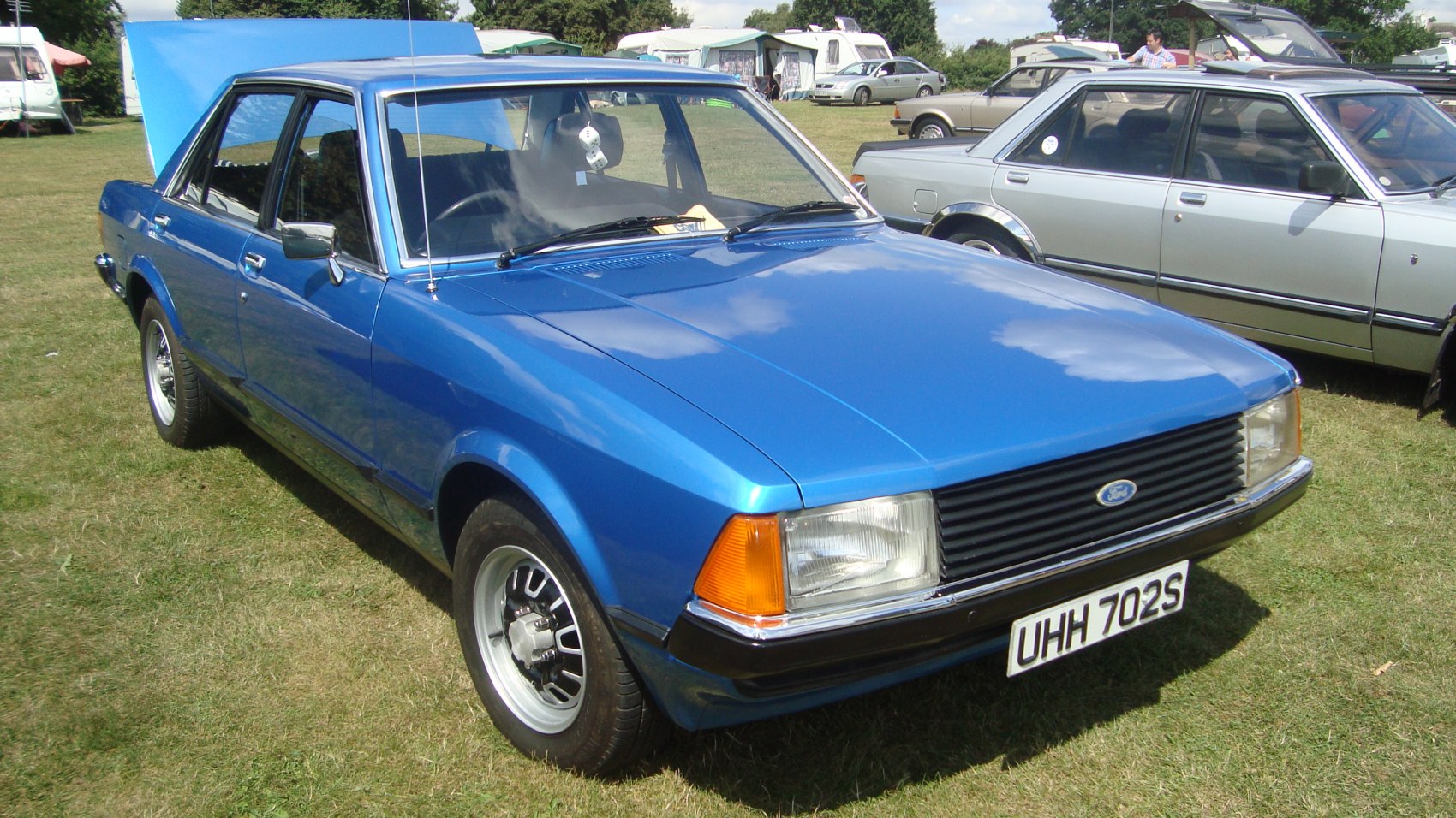 Blue sedan with squared headlights and black grille